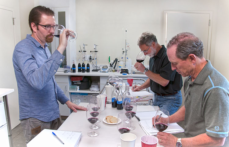 Left to right: Winemaker Louis Skinner conducts lab trials with consulting winemaker Bob Betz and owner Steve Griessel